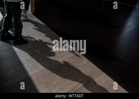 Opened Door and Shadows of Children talking about something in a small Room - picture about mystery play secret Stock Photo