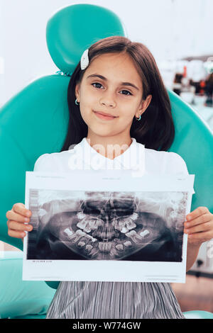 mixed race little girl showing her x-ray teeth picture. Pediatric dentistry Stock Photo