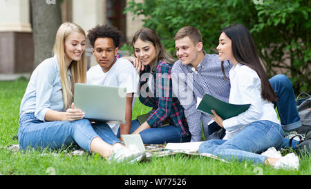 Students studying in group project outdoors in college campus Stock Photo