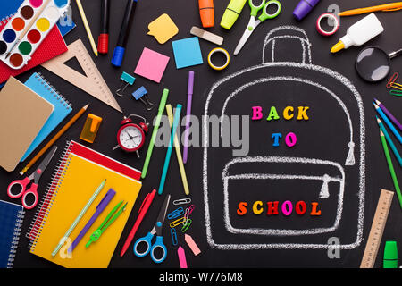 Creativity mess of school supplies and chalk painted backpack Stock Photo