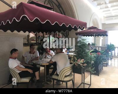 28 June 2019, China, Dongguan: Huawei employees take a break in a Parisian-style café on the Ox Horn campus. The USA accuses Huawei of espionage for Beijing and exerts pressure on European countries to stop doing business with the Chinese telecom company. Photo: Simina Mistreanu/dpa Stock Photo