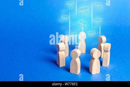 Speech clouds in the center of a people circle. Discussion processes in a team or community. Collaboration and cooperation, participation in a meeting Stock Photo