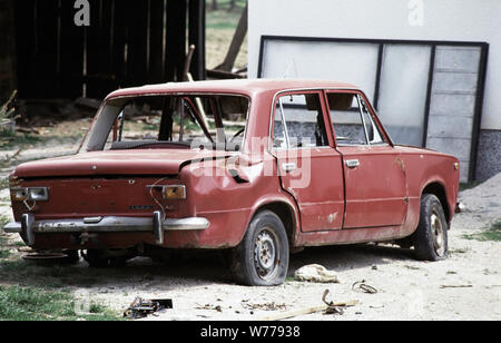 26th April 1993 Ethnic cleansing during the war in central Bosnia: a wrecked Lada car among burned houses along the road between Busovača and Medovici, attacked by HVO (Bosnian Croat) forces ten days before. Stock Photo