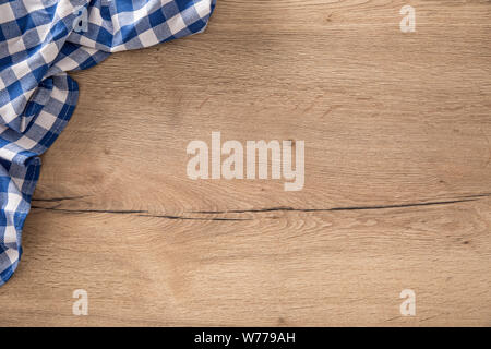 Blue checkered tablecloth on wooden kitchen table. Stock Photo