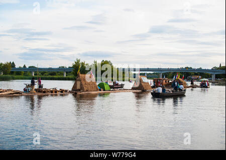 Reconstruction of traditional timber rafting on The Narew river in north-eatern Poland. Stock Photo