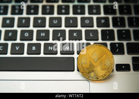 Circle Monerd coin on top of computer keyboard buttons. Digital currency, block chain market, online business Stock Photo