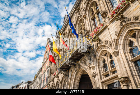 Four flags in city center of Mons, Belgium. European flag, Belgian flag, Walloon flag, Flag of Mons. Stock Photo