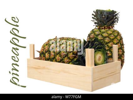 two ripe pineapples in crate isolated on white background Stock Photo