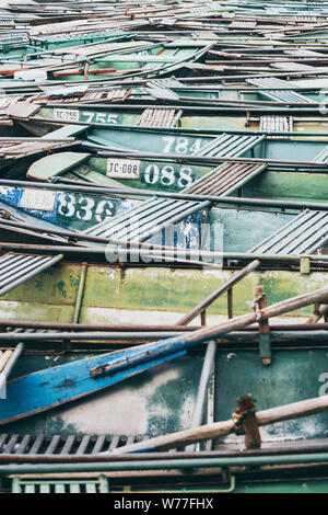 Ninh Binh, Vietnam - May 2019: pattern of rowing tourist boats moored in Tam Coc national park. Stock Photo