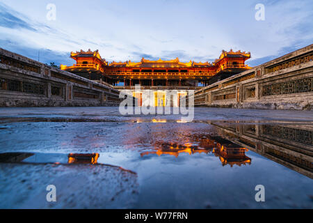 Hue, Vietnam - June 2019: main gate to the purple forbidden imperial city at sunset, reflection in water Stock Photo
