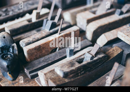 Old carpentry tools in an Asian wooden workshop Stock Photo