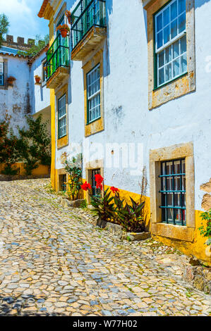 Typical narrow street in the fortified city of Obidos, Leiria District, Estremadura, Portugal Stock Photo