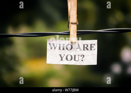 Question Who are you hanging on a clothesline. Concept image. Close up. Stock Photo