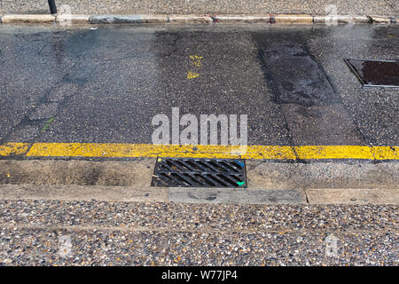 Rainy urban scene with water drops falling on a wet floor Stock Photo