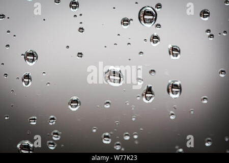 Water drops on a grey glass textured Stock Photo