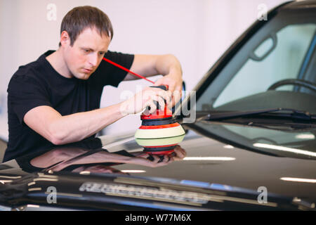 Polishing the car body at the service station. Stock Photo