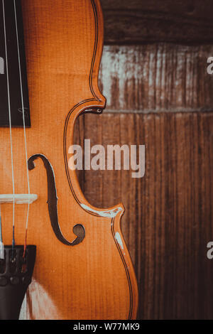 Close up of a violin shallow deep of field on wood background Stock Photo