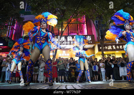 (190805) -- HARBIN, Aug. 5, 2019 (Xinhua) -- Performers are seen on the Central Avenue in Harbin, capital of northeast China's Heilongjiang Province, July 27, 2019. Attracted by the coolness in summer, many tourists come to Harbin for vacation. Meanwhile, Harbin is a city of music for the locals who got in touch with European classical music in an earlier time in China. With the cool summer and rich culture, Harbin received 36.23 million tourists and made revenue of 60.7 billion yuan (8.6 billion U.S. dollars) in the summer of 2018. (Xinhua/Wang Jianwei) Stock Photo