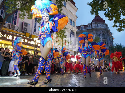 (190805) -- HARBIN, Aug. 5, 2019 (Xinhua) -- Performers are seen on the Central Avenue in Harbin, capital of northeast China's Heilongjiang Province, July 27, 2019. Attracted by the coolness in summer, many tourists come to Harbin for vacation. Meanwhile, Harbin is a city of music for the locals who got in touch with European classical music in an earlier time in China. With the cool summer and rich culture, Harbin received 36.23 million tourists and made revenue of 60.7 billion yuan (8.6 billion U.S. dollars) in the summer of 2018. (Xinhua/Wang Jianwei) Stock Photo