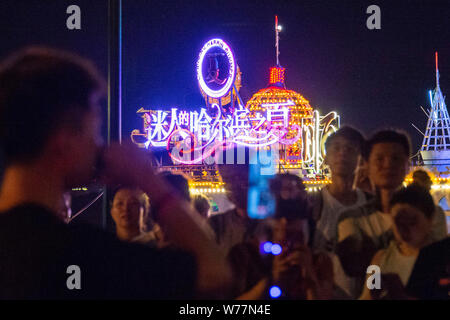 (190805) -- HARBIN, Aug. 5, 2019 (Xinhua) -- People sing along Songhua River in Harbin, capital of northeast China's Heilongjiang Province, July 31, 2019. Attracted by the coolness in summer, many tourists come to Harbin for vacation. Meanwhile, Harbin is a city of music for the locals who got in touch with European classical music in an earlier time in China. With the cool summer and rich culture, Harbin received 36.23 million tourists and made revenue of 60.7 billion yuan (8.6 billion U.S. dollars) in the summer of 2018. (Xinhua/Xie Jianfei) Stock Photo