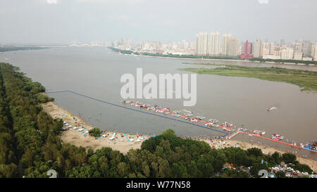 (190805) -- HARBIN, Aug. 5, 2019 (Xinhua) -- Aerial photo taken on July 28, 2019 shows the beach of the Songhua River in Harbin, capital of northeast China's Heilongjiang Province. Attracted by the coolness in summer, many tourists come to Harbin for vacation. Meanwhile, Harbin is a city of music for the locals who got in touch with European classical music in an earlier time in China. With the cool summer and rich culture, Harbin received 36.23 million tourists and made revenue of 60.7 billion yuan (8.6 billion U.S. dollars) in the summer of 2018. (Xinhua/Wang Jianwei) Stock Photo