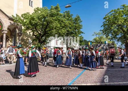 A church group of men and women in traditional Tirolean dress parade through Steinach am Brenner a town near Innsbruck en-route to the Brenner Pass Stock Photo