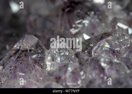 Quartz also called deep quartz with mineral inclusions in the studio in front of black background photographed in Marco mode Stock Photo