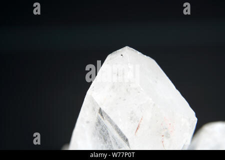 Quartz also called deep quartz with mineral inclusions in the studio in front of black background photographed in Marco mode Stock Photo