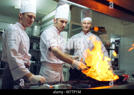Fire in the kitchen. Fire gas burn is cooking on iron pan,stir fire very hot. Stock Photo