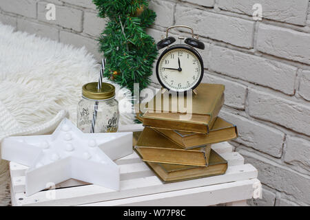 Vintage alarm clock in traditional study room showing fifteen to midnight. Happy New Year! Stock Photo