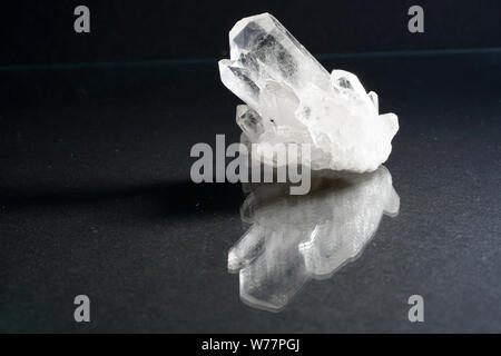 Quartz also called deep quartz with mineral inclusions in the studio in front of black background photographed in Marco mode Stock Photo