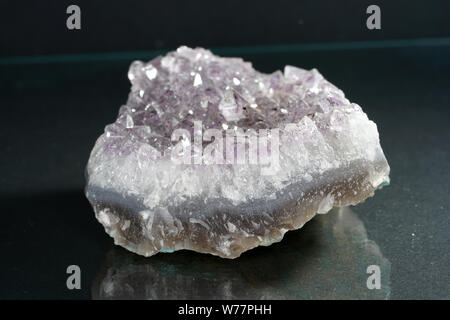 Quartz also called deep quartz with mineral inclusions in the studio in front of black background photographed in Marco mode Stock Photo