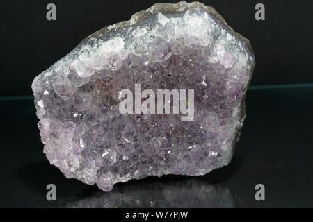 Quartz also called deep quartz with mineral inclusions in the studio in front of black background photographed in Marco mode Stock Photo