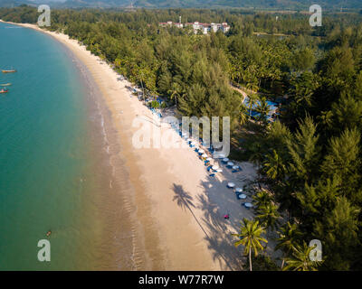 Beautiful late evening shadows on a deserted tropical beach viewed from the air Stock Photo