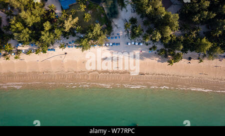 Aerial drone view of a beautiful empty sandy beach and tropical coastline Stock Photo