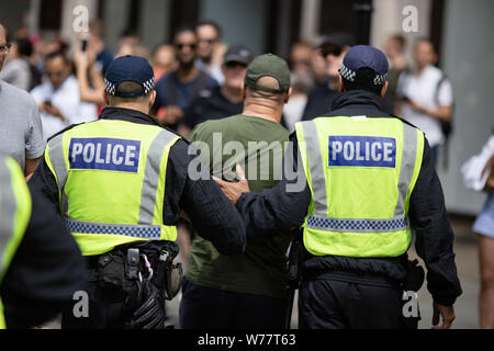 London, UK. 3rd Aug, 2018. Policemen arrest a 'Free Tommy' demonstrator during the protest.''˜Free Tommy' demonstrators took to the streets of London demanding the release of jailed far-right activist Tommy Robinson. Anti-Fascist demonstrators countered the protest, declaring that supporters of Tommy Robinson ''˜can't march unopposedâ Credit: Ryan Ashcroft/SOPA Images/ZUMA Wire/Alamy Live News Stock Photo
