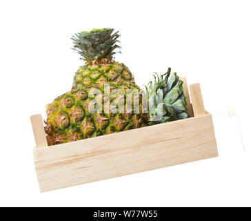 two pineapples in crate isolated on white background Stock Photo