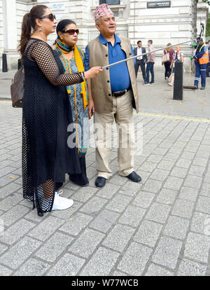 London, England, UK. Indian family in Whitehall taking a group selfie Stock Photo