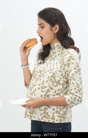 Pregnant woman eating burger