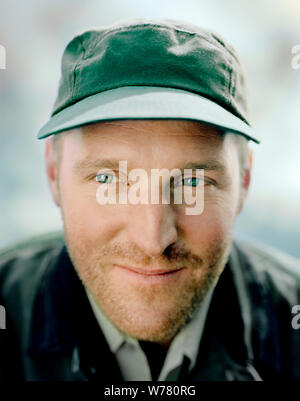 Bearded mid-adult man wearing a green cap. Stock Photo