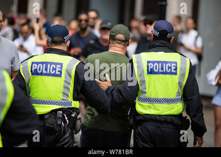 Policemen arrest a 'Free Tommy' demonstrator during the protest.‘Free Tommy’ demonstrators took to the streets of London demanding the release of jailed far-right activist Tommy Robinson. Anti-Fascist demonstrators countered the protest, declaring that supporters of Tommy Robinson ‘can’t march unopposed’. Stock Photo