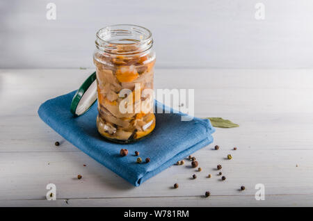 pickled mushrooms in a glass jar on a white background Stock Photo