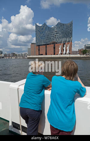 teenagers on Elbe ferry passing Elbe philharmonic hall, Hamburg, Germany Stock Photo