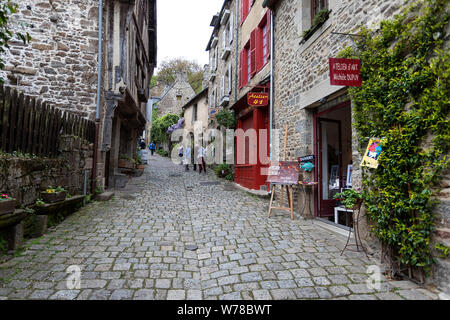 Picturesque cobblestone street and old half timbered and stone buildings buildings in the old town of Dinan in Brittany, France Stock Photo