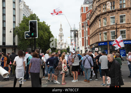 London, UK. 3rd August 2019. Tommy Robinson supporters, after holding a rally near Oxford Circus, occupying the crossing in the Strand to Waterloo Bridge. Credit: Joe Kuis / Alamy News Stock Photo