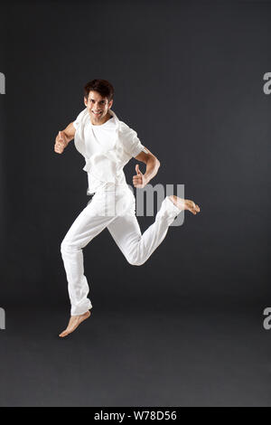 Young man jumping in mid air Stock Photo