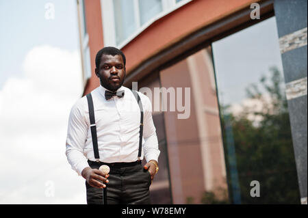 Handsome fashionable african american man in formal wear, bow tie and  suspenders, walking stick. 10500392 Stock Photo at Vecteezy