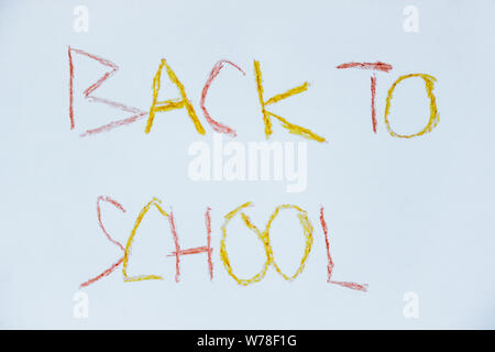 Sign Back to School hand written by a pupil. Children handwriting. Red and yellow letters. Beginning of the new school year 2019, 2020. Stock Photo