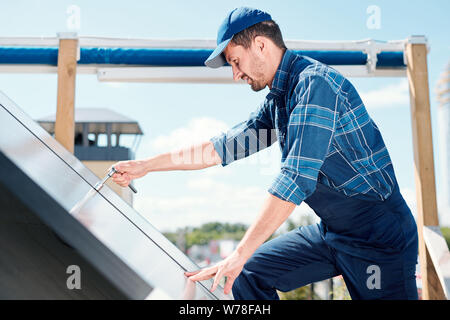Young contemporary technician of customer service repairing handle Stock Photo