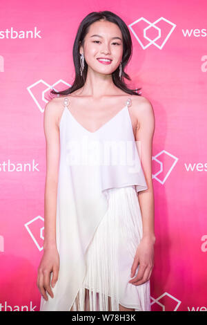 Victoria's Secret Angel and Chinese model Xie Xin poses as she arrives on the red carpet for 'Fight For Beauty' exhibition held by Canada's Premier Re Stock Photo